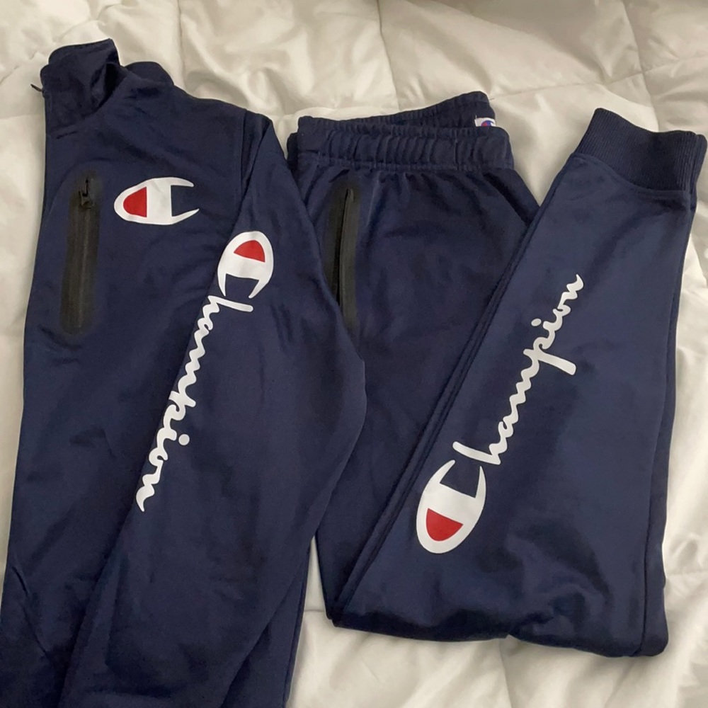 Champions track suit in Navy blue. Size medium.